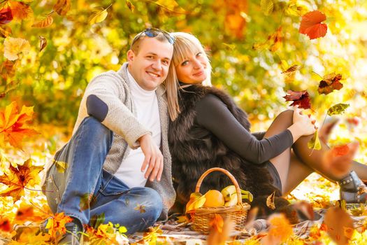 Young couple in love holding hands and walking through a park on a sunny autumn day. High quality photo