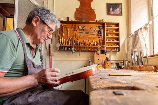 violinmaker at work in his italian workshop