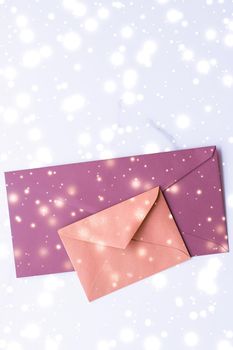 Greetings, postal service and online newsletter concept - Winter holiday blank paper envelopes on marble with shiny snow flatlay background, love letter or Christmas mail card design