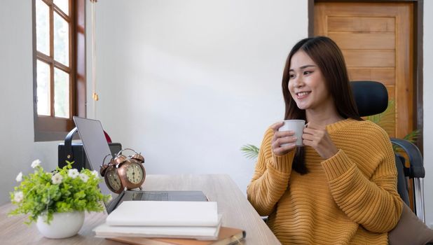 Profile side photo of smart chinese girl ceo expert sit desk work remote laptop texting typing report hold beverage mug in house indoors.