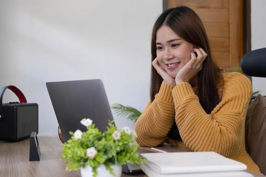 Happy casual beautiful woman working on a laptop. freelancer,work from home concept..