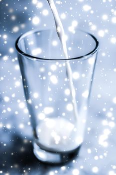 Dairy products, healthy diet and Christmas food concept - Magic holiday drink, pouring organic lactose free milk into glass on marble table