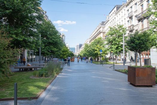 BRUSSELS, BELGIUM - June 02, 2022: a crowded 'Rue Antoine Dansaert shopping street in Brussels, Belgium during a summer day. High quality photo