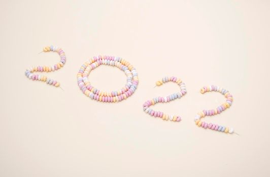 figures of the year 2022 lined with pastel colors candies lettering High quality photo
