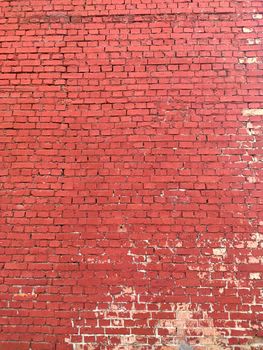 Colorful red brick wall on the house. Texture of red stone blocks, close up. Background. Old building.