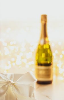 Romantic celebration, lifestyle and luxury present concept - The bottle of champagne and holiday gift box