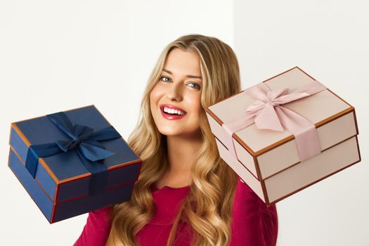 Happy woman holding gifts for birthday, anniversary, wedding, Valentines day or Christmas, luxury holiday present or beauty box subscription delivery concept