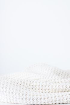 Knitwear, fabric textures and handmade items concept - Warm knitted clothes, soft and white