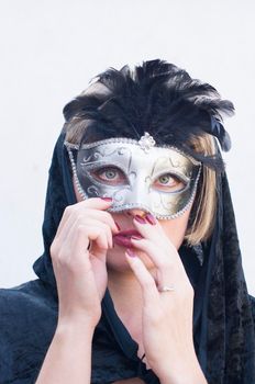 Mysterious Girl in a black cloak and a masquerade mask, mardi gras steampunk mask, a fairy tale, an enchanting story, High quality photo