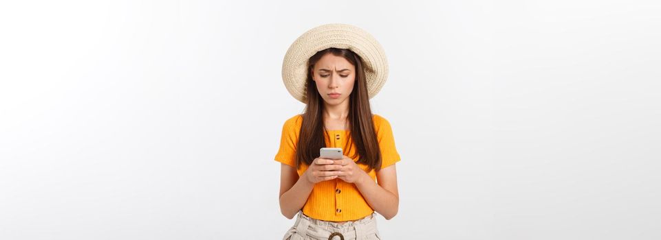 Profile portrait of good-looking attractive woman holding smartphone in hand and using it with serious face expression