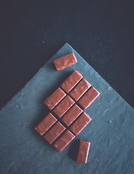 Dessert, confectionery and gluten-free organic food concept - Sweet swiss chocolate candies on a stone tabletop, flatlay