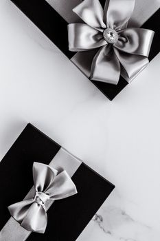 Present for him, shop sale promotion and anniversary celebration concept - Luxury holiday gifts with silver silk ribbon and bow on marble background