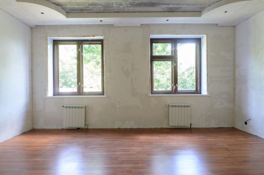 Interior of empty room during renovation, wall view with windows a