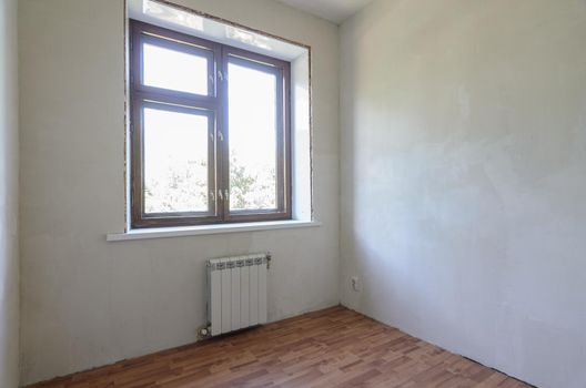 View of the window in a small room after renovation a