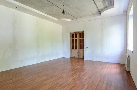 Interior of an empty room prepared for wallpapering a