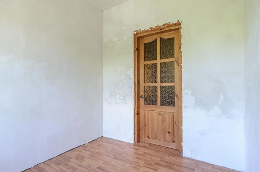 View of the front door in a small room after renovation a