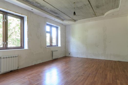 Interior of an empty room during renovation in the room two large windows a
