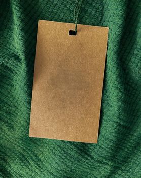 Blank fashion label tag, sale price card on luxury fabric background, shopping and retail concept