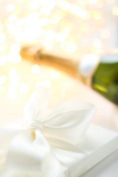 Romantic celebration, lifestyle and luxury present concept - The bottle of champagne and holiday gift box