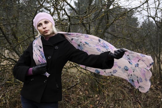 Portrait of young blonde woman in forest