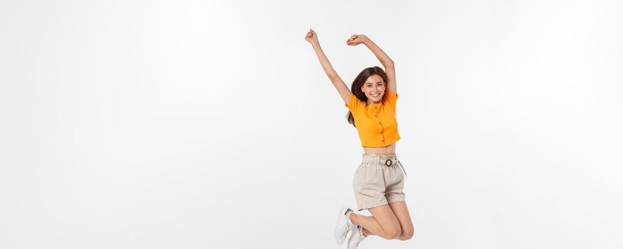 Cool hipster portrait of young stylish teen girl showing her hands up, positive mood and emotions,travel alone. Isolated over grey background.