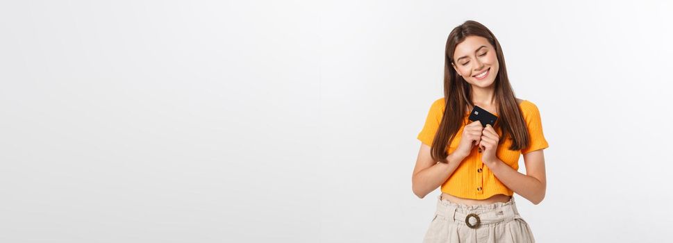 beautiful friendly smiling confident girl showing black card in hand, isolated over white background