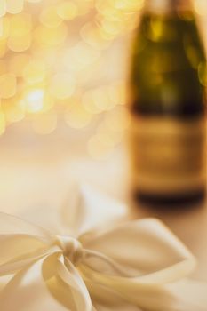 Romantic celebration, lifestyle and luxury present concept - The bottle of champagne and holiday gift box