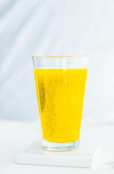 Healthy nutrition, organic drink and fasting cleanse concept - Glass of yellow fruit smoothie juice with chia seeds for diet detox, perfect breakfast recipe