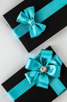 Birthday present, shop sale promotion and anniversary celebration concept - Luxury holiday gifts with emerald silk ribbon and bow on marble background