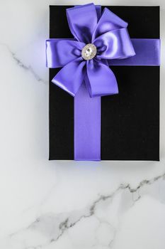 Wedding present, shop sale promotion and anniversary celebration concept - Luxury holiday gifts with lavender silk ribbon and bow on marble background