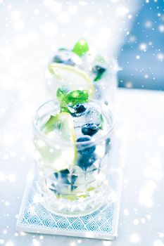 Cold icy drink, luxury bar and New Years Eve party celebration concept - Winter holiday cocktail with ice and glowing snow on background, Christmas time menu recipe