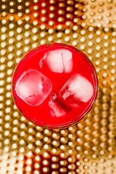 Alcohol drink, refreshment and cold beverage concept - Glass of red cocktail with ice, luxury bar party