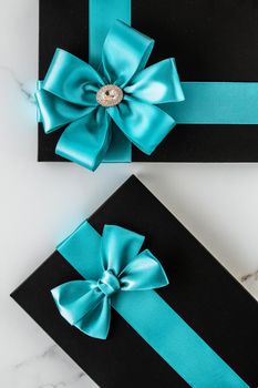 Birthday present, shop sale promotion and anniversary celebration concept - Luxury holiday gifts with emerald silk ribbon and bow on marble background