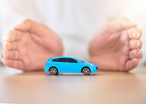 .Hands, car and insurance with a business employee covering transport with her hands in her company office. Finance, saving and transportation with a broker offering to secure your vehicle at work