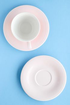 Kitchen, dishware and drinks concept - Empty cup and saucer on blue background, flatlay