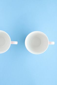 Kitchen, dishware and drinks concept - Empty cup and saucer on blue background, flatlay