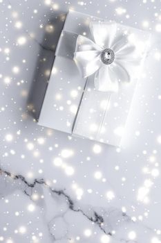 New Years Eve celebration, winter decoration and Valentines Day presents concept - Luxury holiday gifts with white silk bow and ribbons on marble background, Christmas time surprise