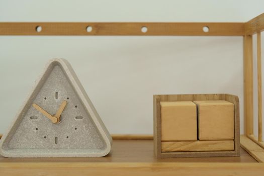 Wooden blocks and clocks placed on wooden shelves.