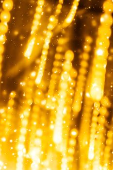 Golden Christmas lights, New Years Eve fireworks and abstract texture concept - Glamorous gold shiny glow and glitter, luxury holiday background