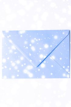 Greetings, postal service and online newsletter concept - Winter holiday blank paper envelopes on marble with shiny snow flatlay background, love letter or Christmas mail card design