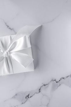 Romantic celebration, bridal decor and holiday present concept - Luxury wedding gifts with silk bow and ribbons on marble background