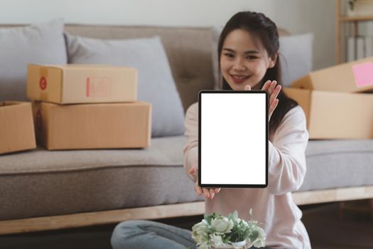 Asian SME business woman showing tablet empty screen at home office. Marketing time banner template.
