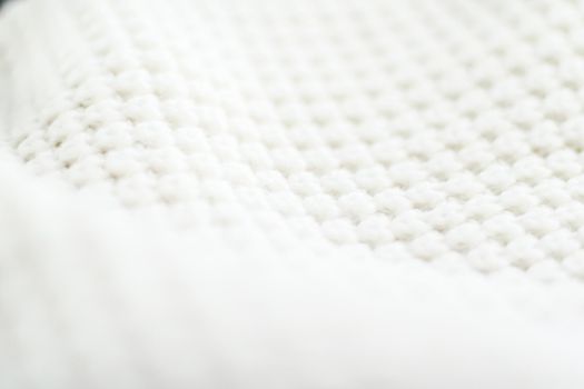 Knitwear, fabric textures and handmade items concept - Warm knitted clothes, soft and white