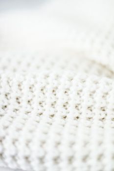 Knitwear, fabric textures and handmade items concept - Warm knitted clothes, soft and white