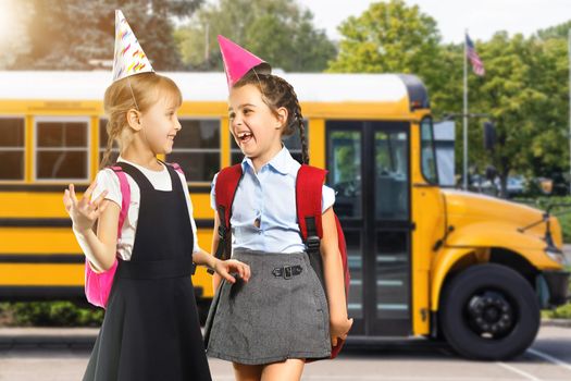 Little kids schoolchildren pupils students, the school bus. Welcome back to school. The new academic semester year start.