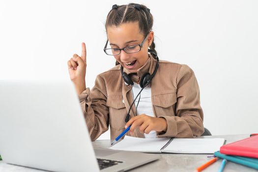 Online Education. Cute little Girl Study At Home With Laptop And Wireless Headphones, Adorable Kid Having Web Lesson With Teacher, Enjoying Distance Learning During Quarantine Time, Free Space.