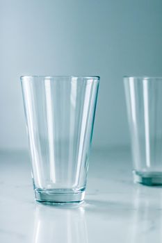 Glassware, washing and purity concept - Clean empty glasses on marble table