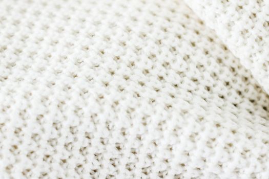 Knitwear, fabric textures and handmade items concept - Warm knitted clothes, soft and white