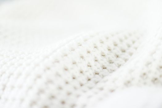 Knitwear, fabric textures and handmade items concept - Warm knitted clothes, soft and white