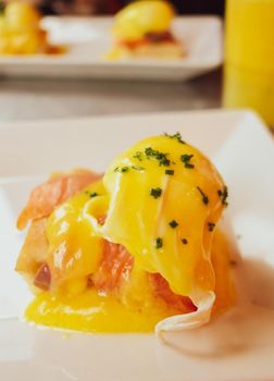 Restaurant service, food recipes and breakfast concept - Poached egg with salmon for brunch in a luxury restaurant